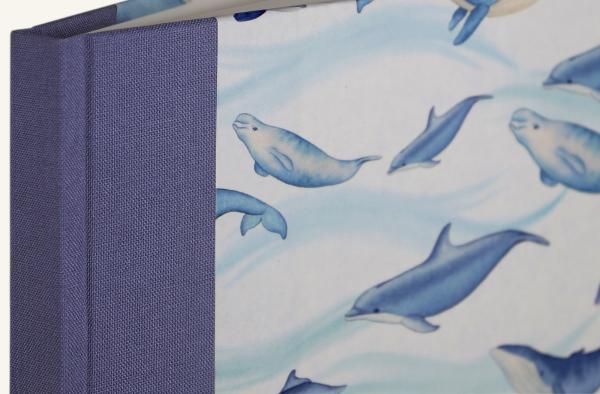 Notebook with colorful whales motif, blue linen spine